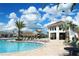 Stunning pool area with a tiki bar, comfortable lounge chairs, and clear blue water at 2964 Protagonist St, Kissimmee, FL 34746