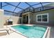 Relaxing screened-in pool area with patio seating and a grill, ideal for outdoor entertaining and leisure at 2964 Protagonist St, Kissimmee, FL 34746