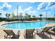 Resort-style swimming pool surrounded by lounge chairs and lush landscaping at 2964 Protagonist St, Kissimmee, FL 34746