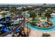 Aerial view of a vibrant water park with slides, a lazy river, and mini-golf at 2964 Protagonist St, Kissimmee, FL 34746