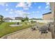 Wide backyard featuring ample seating, a fire pit, and verdant grass at 3087 Somerset Park Dr, Orlando, FL 32824