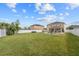 Expansive backyard featuring a lush lawn, outdoor seating, and a fire pit, perfect for entertaining and relaxation at 3087 Somerset Park Dr, Orlando, FL 32824