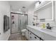 Modern bathroom with double vanity, illuminated mirror, and glass-enclosed shower at 3087 Somerset Park Dr, Orlando, FL 32824