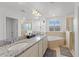 A primary bathroom featuring double sinks, a large mirror, and a luxurious soaking tub at 3087 Somerset Park Dr, Orlando, FL 32824