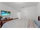 Bright bedroom featuring a TV, light walls, and complementing dark wood dresser at 3087 Somerset Park Dr, Orlando, FL 32824