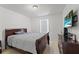 Comfortable bedroom featuring a cozy bed and dark wooden dresser at 3087 Somerset Park Dr, Orlando, FL 32824