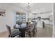 Open dining area with a stylish table, leading to the kitchen and outdoor patio at 3087 Somerset Park Dr, Orlando, FL 32824