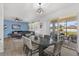 Bright dining area with a modern table and chairs, connecting to the living room and patio at 3087 Somerset Park Dr, Orlando, FL 32824