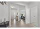 Bright entryway featuring wood floors, white walls and views of an open living space with neutral decor at 3087 Somerset Park Dr, Orlando, FL 32824