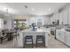 Bright kitchen with a center island, white cabinets, and a view of the dining area at 3087 Somerset Park Dr, Orlando, FL 32824