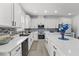 Modern kitchen with white cabinets, stainless steel appliances, and a stylish backsplash at 3087 Somerset Park Dr, Orlando, FL 32824