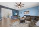 Comfortable living room featuring a plush sectional sofa, ceiling fan, and modern decor at 3087 Somerset Park Dr, Orlando, FL 32824