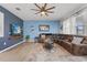 Bright living room with a large sectional sofa, ceiling fan, and stylish rug at 3087 Somerset Park Dr, Orlando, FL 32824