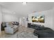 Cozy living area with comfortable seating, a large TV, and neutral decor at 3087 Somerset Park Dr, Orlando, FL 32824