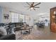 Open-concept living room with a sectional sofa, dining area, and access to the kitchen at 3087 Somerset Park Dr, Orlando, FL 32824