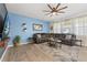 Inviting living room with a comfortable sectional sofa and large windows at 3087 Somerset Park Dr, Orlando, FL 32824