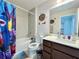Colorful bathroom with vanity, toilet, shower/tub combo, and tile surround at 3954 Great Smokey Way, Apopka, FL 32712