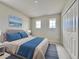 Comfortable bedroom showcasing a bed with blue accents, soft carpet, and ample natural light at 3954 Great Smokey Way, Apopka, FL 32712
