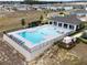 Aerial view of a community pool with shaded seating and lounge chairs, perfect for relaxing and socializing at 3954 Great Smokey Way, Apopka, FL 32712