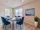 Dining area featuring a modern table with six blue chairs and contemporary decor at 3954 Great Smokey Way, Apopka, FL 32712