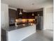 Modern kitchen featuring stainless steel appliances, granite countertops, and dark wood cabinets at 3954 Great Smokey Way, Apopka, FL 32712