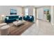Comfortable living room with elegant decor, blue sofa set, and neutral color scheme at 3954 Great Smokey Way, Apopka, FL 32712