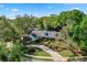 Aerial view of a home with mature landscaping and a charming brick driveway at 420 Wild Oak Cir, Longwood, FL 32779