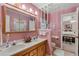 Bathroom featuring dual sinks, a toilet, and a shower room, offering space and convenience at 420 Wild Oak Cir, Longwood, FL 32779