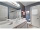 Bathroom with a white vanity, shower, and blue floral wallpaper at 420 Wild Oak Cir, Longwood, FL 32779