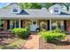Charming brick home featuring a welcoming front door with a wreath and mature landscaping at 420 Wild Oak Cir, Longwood, FL 32779
