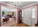 Inviting foyer featuring hardwood floors, a grand clock, and a glimpse into the formal living room at 420 Wild Oak Cir, Longwood, FL 32779