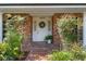 Inviting front entrance with brick facade, a decorative wreath, and lush greenery at 420 Wild Oak Cir, Longwood, FL 32779