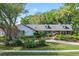 Charming single-story home with a brick and siding exterior, dormer windows and mature landscaping at 420 Wild Oak Cir, Longwood, FL 32779