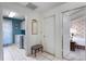 Hallway featuring white tile, doors to the laundry and a bedroom at 420 Wild Oak Cir, Longwood, FL 32779