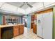Efficient kitchen featuring a refrigerator, tile floors, wood cabinets, and a view to breakfast nook at 420 Wild Oak Cir, Longwood, FL 32779