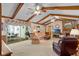 Relaxing living room featuring wood beam ceiling, brick fireplace and ample seating area at 420 Wild Oak Cir, Longwood, FL 32779