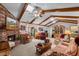 Cozy living room featuring a brick fireplace, beamed ceiling, and comfortable seating at 420 Wild Oak Cir, Longwood, FL 32779