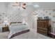 Vaulted ceiling and skylight highlight this bedroom with a ceiling fan, floral wallpaper, and private access at 420 Wild Oak Cir, Longwood, FL 32779