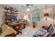 Comfortable home office with wooden desk, shelving and charming striped wallpaper at 420 Wild Oak Cir, Longwood, FL 32779