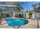 Inviting screened-in pool with clear blue water, surrounded by a spacious patio and lush greenery at 420 Wild Oak Cir, Longwood, FL 32779