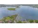Beautiful aerial view of a large lake with lush islands and waterfront homes at 4231 Yorketowne Rd, Orlando, FL 32812