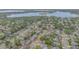 Aerial view of neighborhood and community featuring mature trees and multiple lakes in the distance at 4231 Yorketowne Rd, Orlando, FL 32812