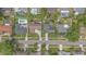 Aerial view of neighborhood street featuring a home with a dark roof and a circular driveway at 4231 Yorketowne Rd, Orlando, FL 32812