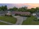 Charming single-story home featuring a large driveway and mature landscaping at 4231 Yorketowne Rd, Orlando, FL 32812