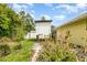 View of the backyard featuring a playhouse and tropical plants at 4231 Yorketowne Rd, Orlando, FL 32812