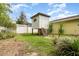 Backyard featuring a playhouse, white fence, and tropical plants at 4231 Yorketowne Rd, Orlando, FL 32812