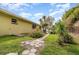 View of the backyard with a stone walkway and some tropical plants at 4231 Yorketowne Rd, Orlando, FL 32812