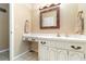 Bathroom vanity featuring custom wood framed mirror and decorative cabinet hardware at 4231 Yorketowne Rd, Orlando, FL 32812