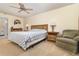 Spacious bedroom features neutral tones, ceiling fan, bedside tables, and a comfortable seating area at 4231 Yorketowne Rd, Orlando, FL 32812