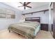 Bright bedroom featuring a ceiling fan, a window with blinds, and a large mirrored closet at 4231 Yorketowne Rd, Orlando, FL 32812